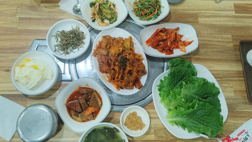 Korean hanjeongsik table with jeyuk bokkeum and 8 GMO-free side dishes