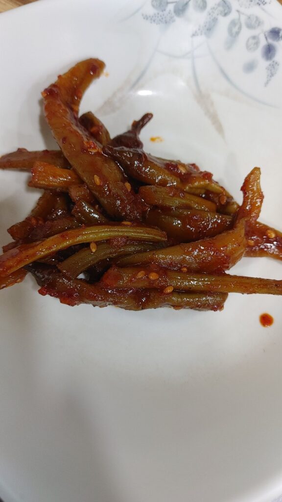 Seasoned Namul - A side dish made by boiling seasonal greens (for 10 minutes in boiling water), draining the water, and tossing them with garlic, sesame oil, and salt.